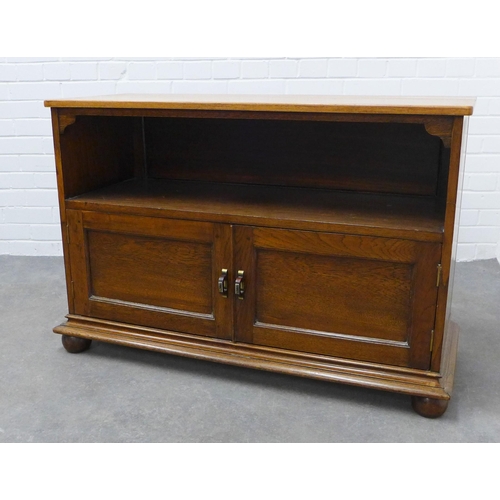 294 - An oak cupboard with an open recess over two doors,  72 x 109 x 42cm.