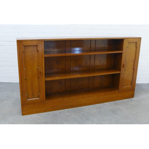 297 - An open bookcase, central shelves flanked by cupboard doors. 93 x 166 x 23cm.