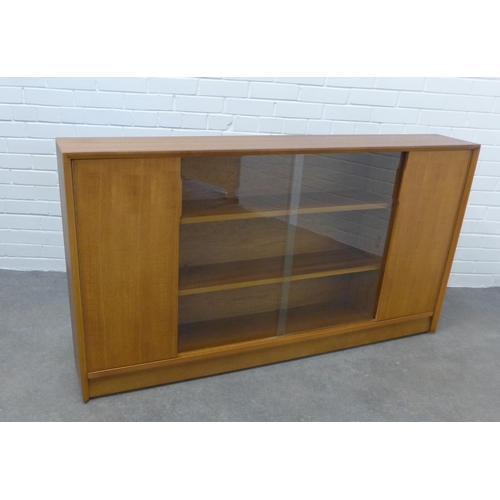 299 - Herbert E.Gibbs teak bookcase with glass sliding doors. 85 x 153 x 25cm.