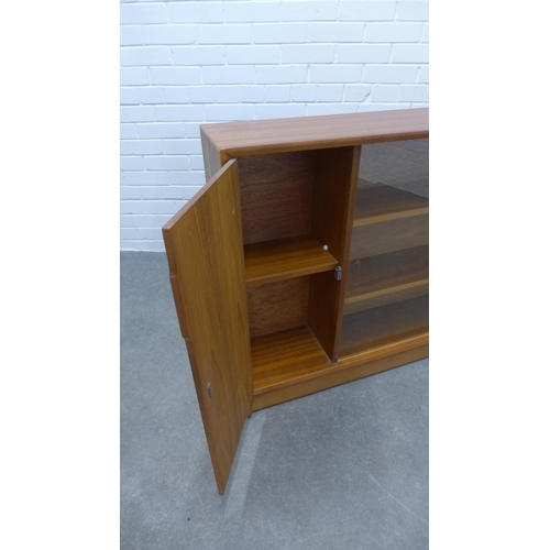 299 - Herbert E.Gibbs teak bookcase with glass sliding doors. 85 x 153 x 25cm.