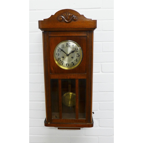 302 - Mahogany cased wall clock, silvered dial and arabic numerals, complete with pendulum . 74 x 33 x 18c... 