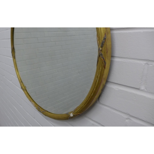 304 - Gilt gesso framed oval wall mirror. 66 x 75cm. (a/f)