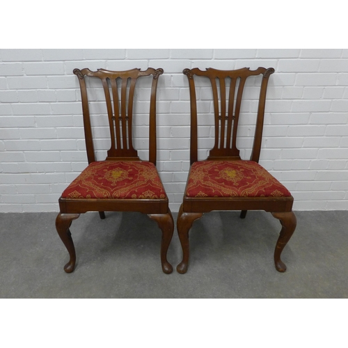 310 - Pair of mahogany side chairs with carved toprails, vertical splat backs and upholstered seats, on ca... 