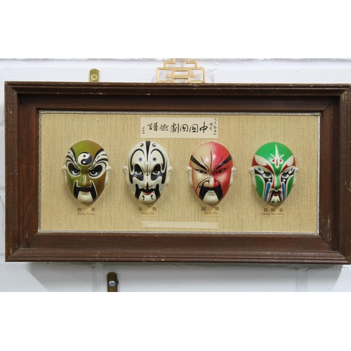 357 - Korean Traditional Masks in a small showcase, 29 x 19cm,  frame and another with four painted face m... 