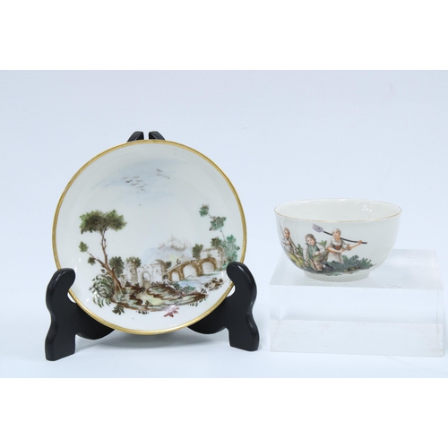 371 - 18th century continental porcelain cup and saucer, painted with figures and rustic landscape, red st... 