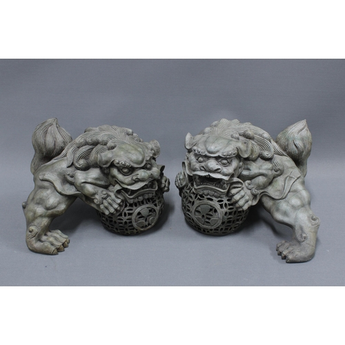 389 - A pair of modern resin Temple Lion figures 24cm long (2)