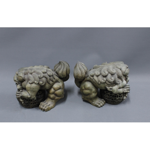 389 - A pair of modern resin Temple Lion figures 24cm long (2)