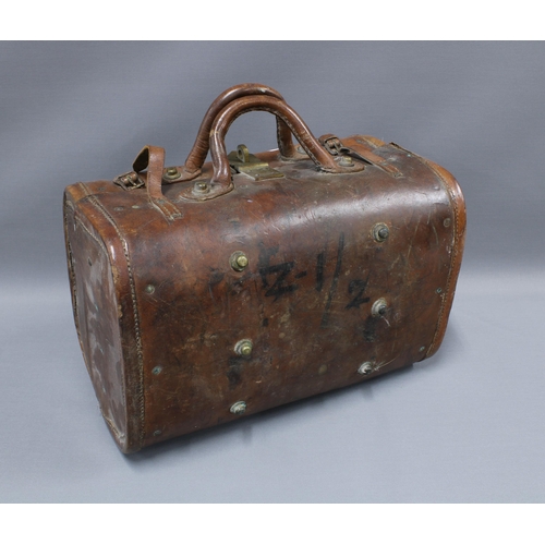 393 - Early 20th century Indian brown leather carry case with interior pockets, brass studs and fittings, ... 