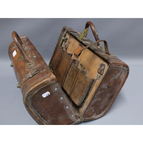 393 - Early 20th century Indian brown leather carry case with interior pockets, brass studs and fittings, ... 