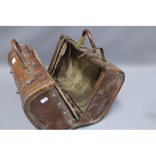 393 - Early 20th century Indian brown leather carry case with interior pockets, brass studs and fittings, ... 