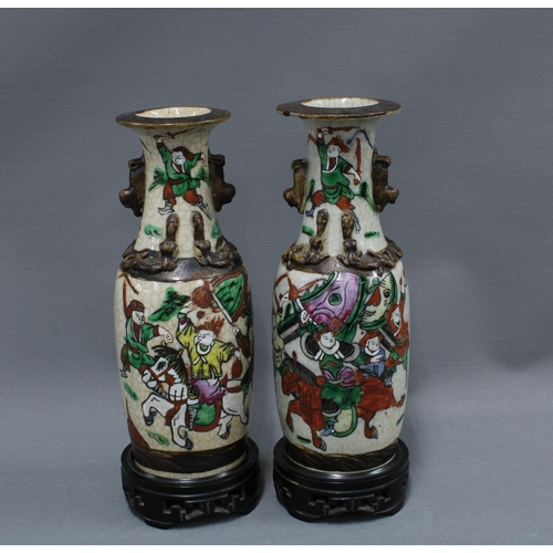 407 - Pair of Chinese crackle ground vases with warrior pattern, 25cm (one a/f) (2)