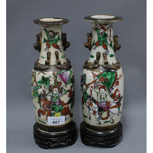 407 - Pair of Chinese crackle ground vases with warrior pattern, 25cm (one a/f) (2)