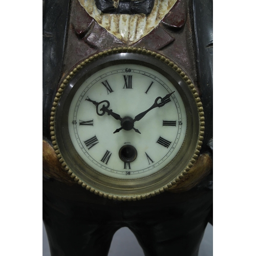 408 - Figural spelter clock with moving eyes, 38cm