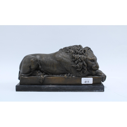 411 - Modern bronze study of a recumbent lion, on a black plinth 32 x 16cm