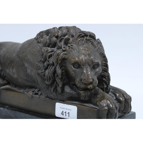 411 - Modern bronze study of a recumbent lion, on a black plinth 32 x 16cm