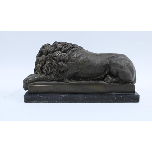 411 - Modern bronze study of a recumbent lion, on a black plinth 32 x 16cm