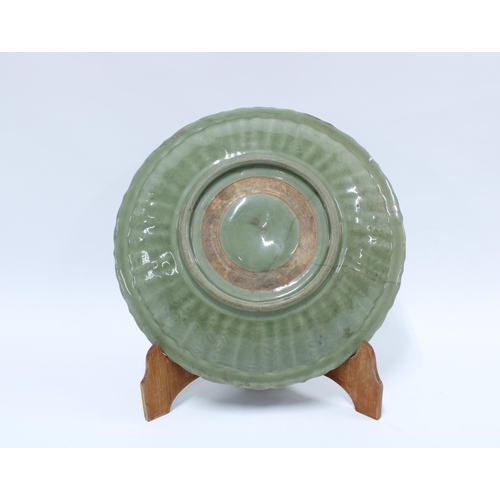 412 - Antique Chinese celadon glazed charger with lobed edge and incised pattern of foliage, star crack in... 