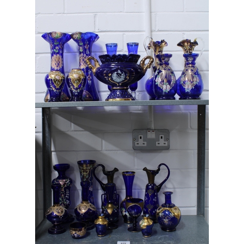 429 - A large collection of Bohemian blue glass, (over two shelves) (24)