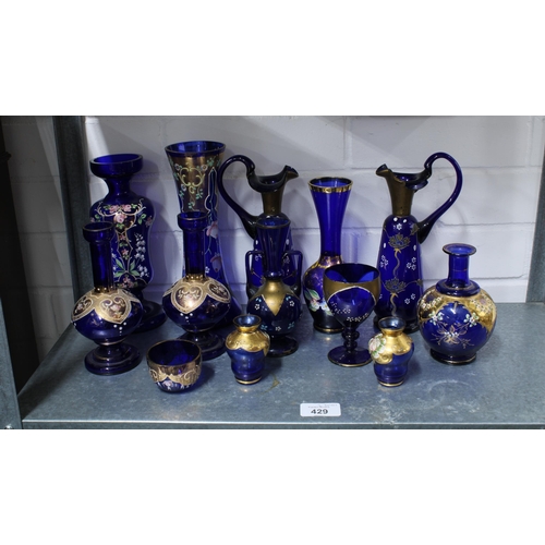 429 - A large collection of Bohemian blue glass, (over two shelves) (24)