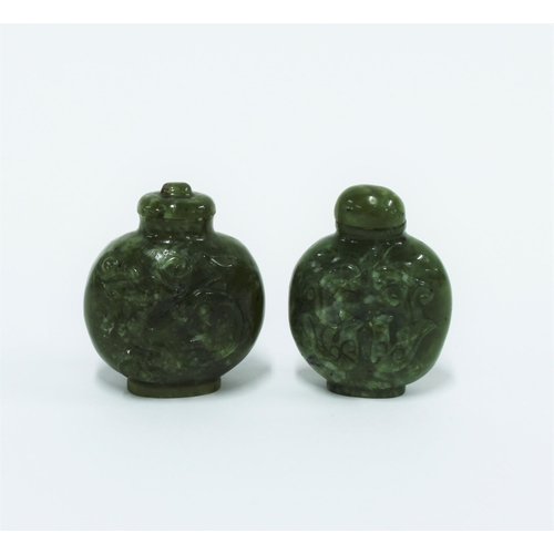 449 - Two Chinese carved jadeite snuff bottles with stoppers, 6cm high (2)