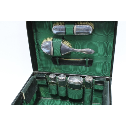 77 - Early 20th century brown leather cased silver mounted travelling toilet set, London 1914