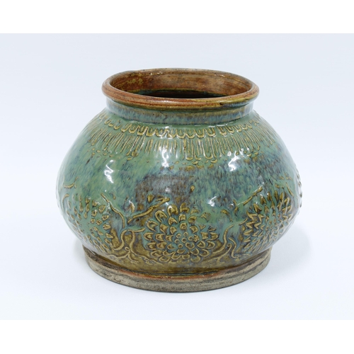 92 - Provincial Chinese stoneware pot, green glazed with floral pattern in relief, 13 x 18cm.