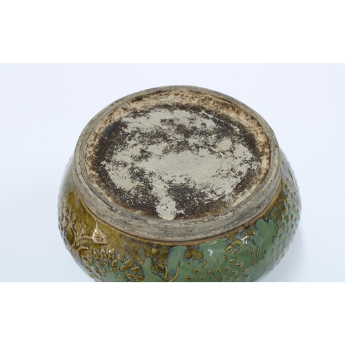 92 - Provincial Chinese stoneware pot, green glazed with floral pattern in relief, 13 x 18cm.