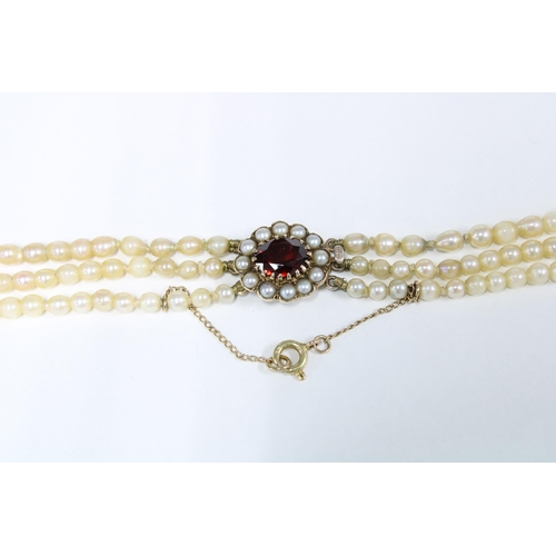 1 - Vintage triple strand cultured pearl necklace with a 9ct gold garnet and seed pearl clasp, stamped 3... 