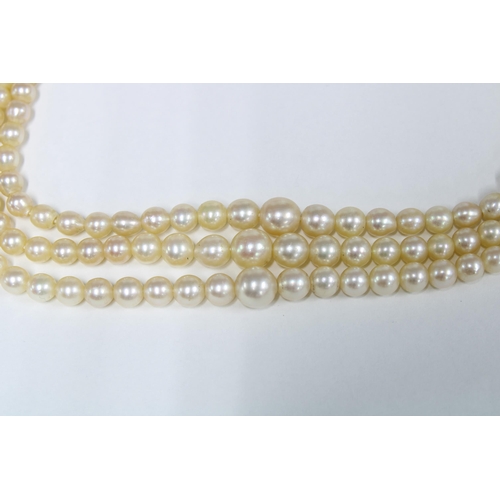 1 - Vintage triple strand cultured pearl necklace with a 9ct gold garnet and seed pearl clasp, stamped 3... 