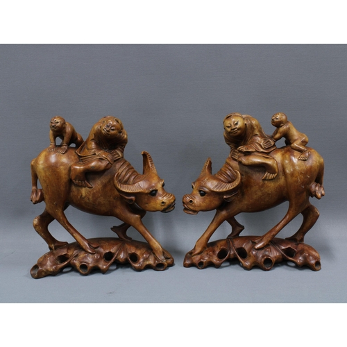 169 - Pair of carved water buffalo figures, 23cm (2)