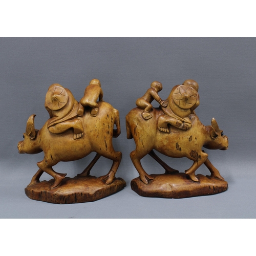 169 - Pair of carved water buffalo figures, 23cm (2)