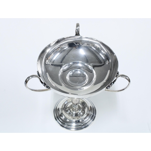 26 - George V silver comport, the raised bowl with three looping handles on a baluster stem and spreading... 