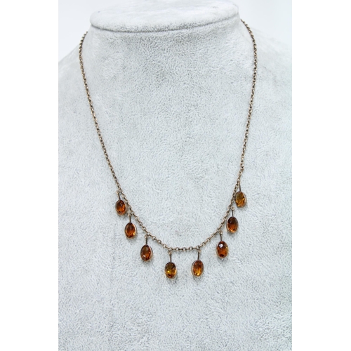 5 - 9ct gold necklace with eight citrine coloured drops, stamped 9ct