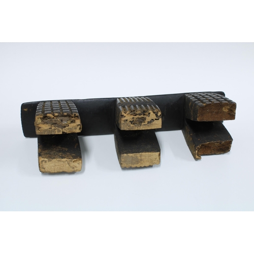 56 - South African Zulu wooden neck rest on three linear pattern supports, 39.5cm long