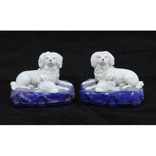 122 - Pair of porcelain dog and pup figure groups, on blue cushions bearing gold anchor backstamps, togeth... 