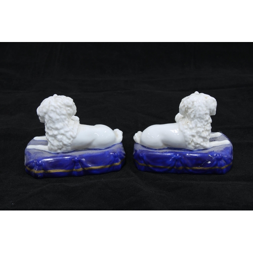 122 - Pair of porcelain dog and pup figure groups, on blue cushions bearing gold anchor backstamps, togeth... 