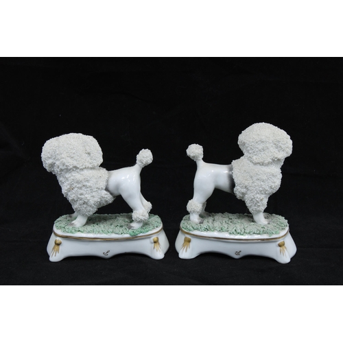 124 - A pair of dogs with basket of flowers figures, gold anchor marks together with a smaller pair of dog... 