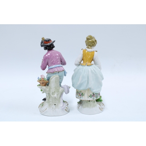 137 - A pair of Sitzendorf porcelain male and female gardening figures, (2) 17cm.