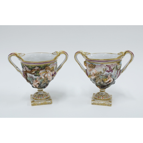 168 - A pair of Capodimonte Bacchus urn vases (2) 14cm.