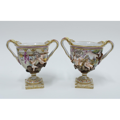 168 - A pair of Capodimonte Bacchus urn vases (2) 14cm.