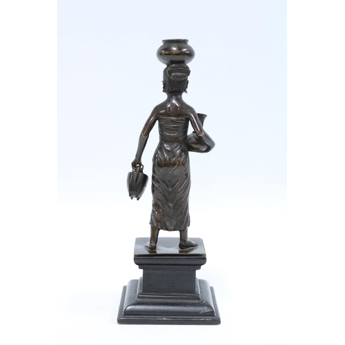 180 - Bronze figure of a female water carrier, 24cm.