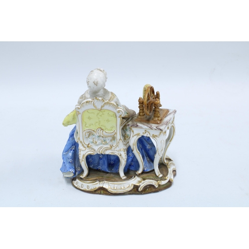 190 - 19th century porcelain figure of a woman sat in a high back chair beside a spinning wheel, blue cros... 