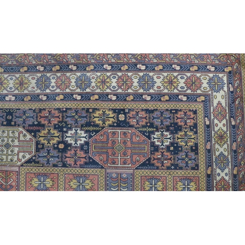 201 - Eastern carpet, blue field with four rows of seven octagons, 318 x 414cm