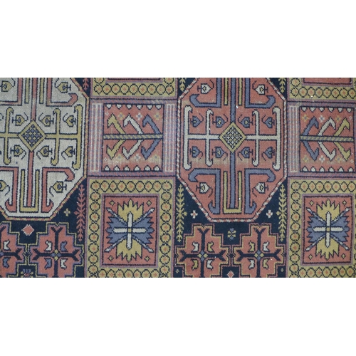 201 - Eastern carpet, blue field with four rows of seven octagons, 318 x 414cm