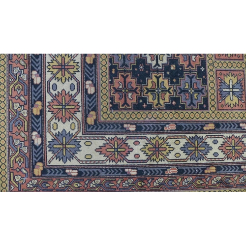 201 - Eastern carpet, blue field with four rows of seven octagons, 318 x 414cm