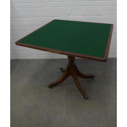 237 - Reproduction fold over card table on outswept  reeded legs with brass caps and castors, 75 x 85cm