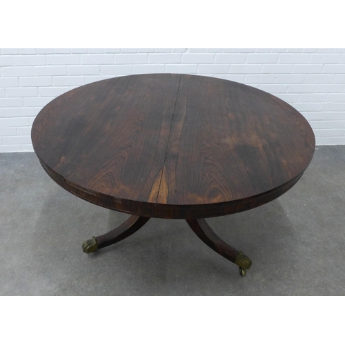 256 - 19th century rosewood breakfast table, circular tilt top on ring turned column and hipped outswept l... 