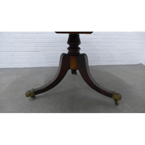 256 - 19th century rosewood breakfast table, circular tilt top on ring turned column and hipped outswept l... 