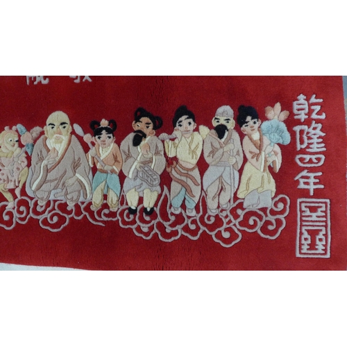 273 - Chinese rug, red field with Immortals and calligraphy. 140 x 80cm.