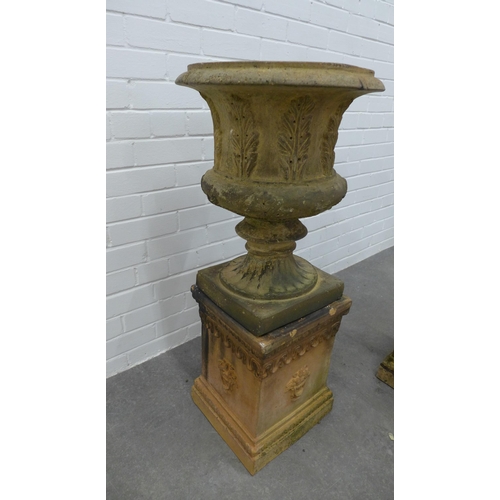 281 - Pair of fireclay garden urns, campana form with acanthus leaf detail, on rectangular plinths . 93 x ... 